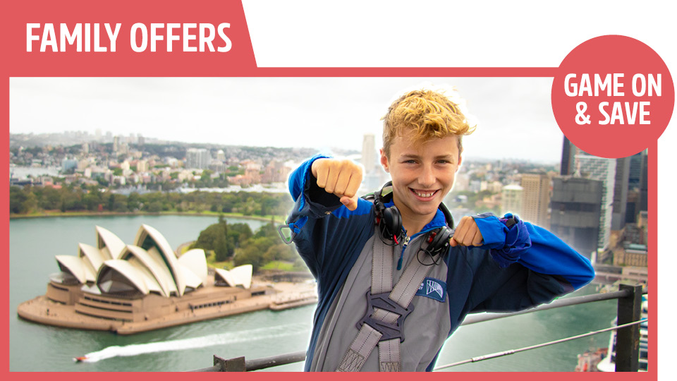 bridgeclimb family school holiday offer with young boy on a bridgeclimb smiling and opera house in the background